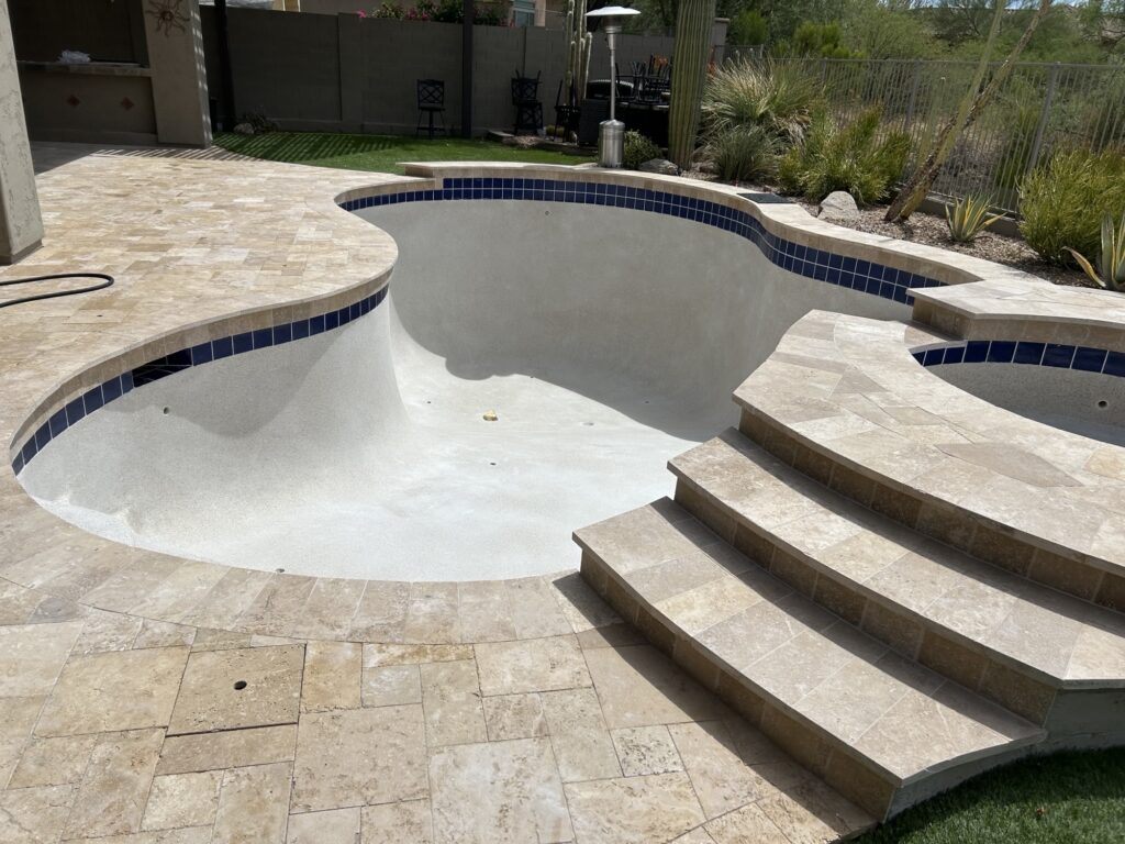 An emptied pool being remodeled for a client.