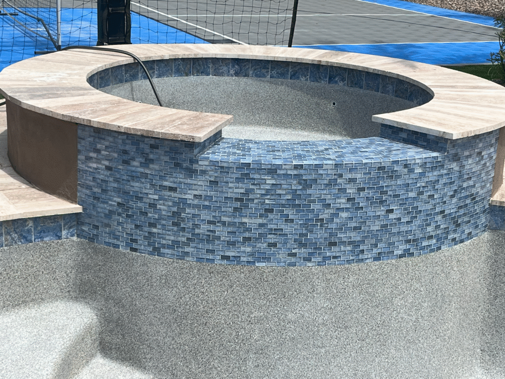 Incredibly well executed pool and hot tub resurfacing using PebbleTech technology.