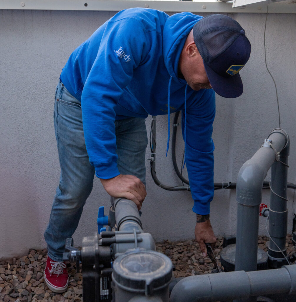 Catalina Pools AZ employee works on a pool pump to make sure all maintenance is preformed regularly.